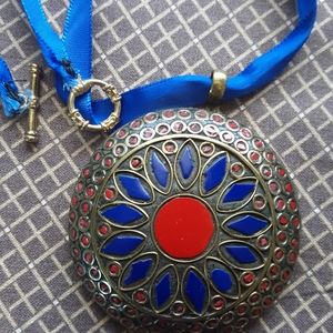 Boho brass inlay large pendant on a satin cord.